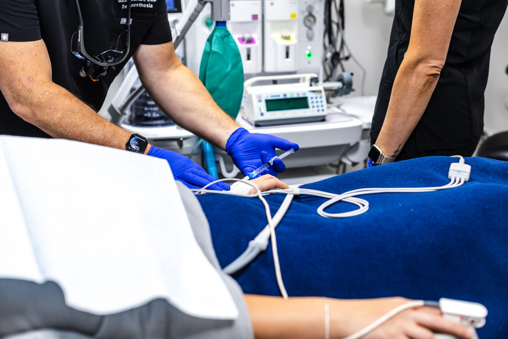 Dental team preparing an IV line for a sedated patient