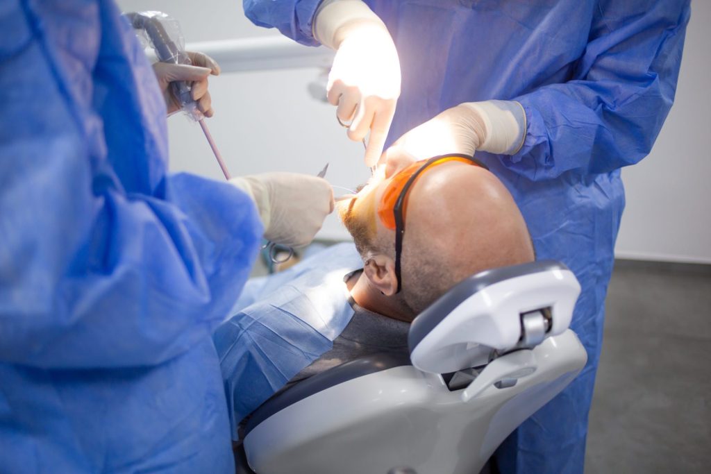 Patient in the dental chair during oral surgery